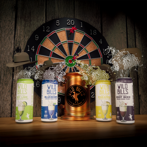 Four cans of Wild Bills beer with a dartboard and hat in the background on a wooden surface.