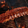 Grilled ribs on a barbecue grill with flames